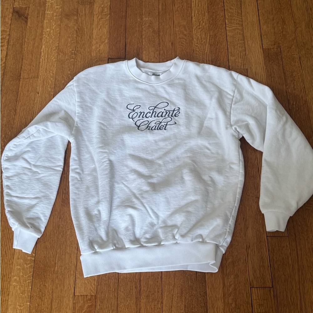 White crewneck Enchanté sweater / jumper from Daniel Riccardo’s brand